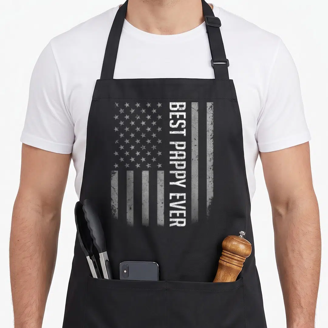 Flag pappy father day apron - Distressed USA flag with vertical white BEST PAPPY EVER text overlaying the stripes — shown on a black cotton canvas apron against a white background