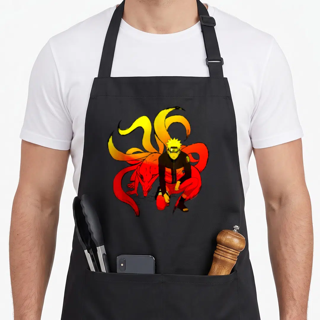 Shippuden general apron - Naruto crouching with red nine-tailed fox cartoon art on black bib — shown on a black cotton canvas apron against a white background
