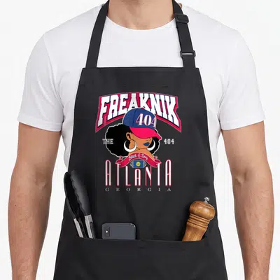 Freaknik tribute apron - Cartoon woman in 404 cap with Freaknik and Atlanta Georgia text — shown on a black cotton canvas apron against a white background
