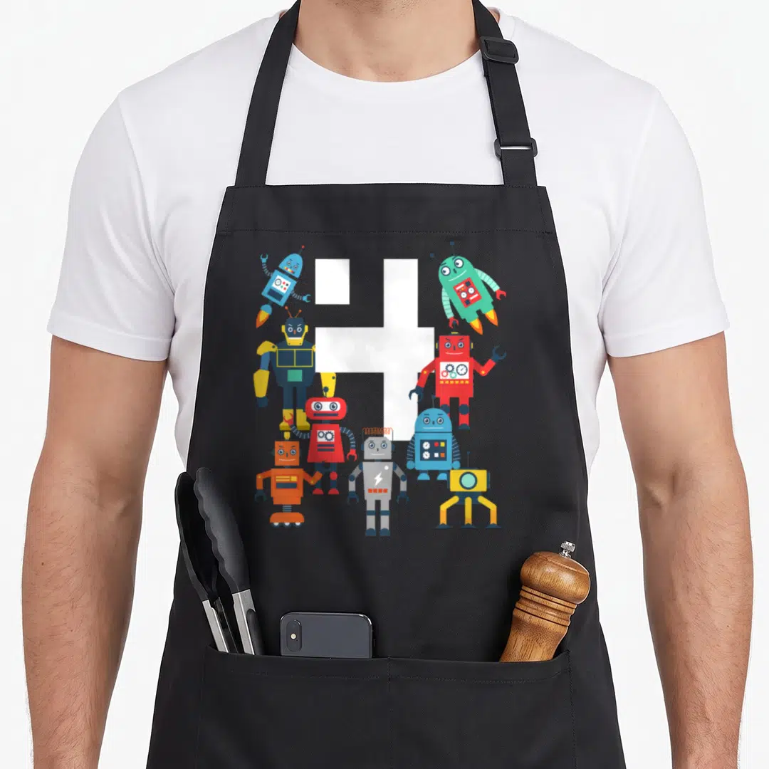 Robotic birthday apron - White number 4 surrounded by colorful cartoon robots in blue, red, yellow, and green — shown on a black cotton canvas apron against a white background