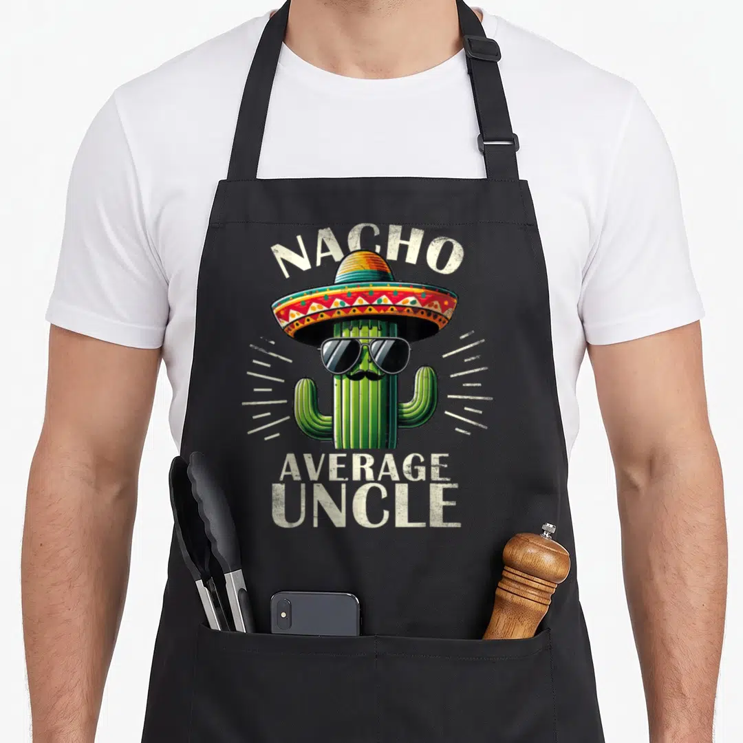 Funny uncle father day apron - Cartoon cactus in sombrero and sunglasses with text Nacho Average Uncle — shown on a black cotton canvas apron against a white background