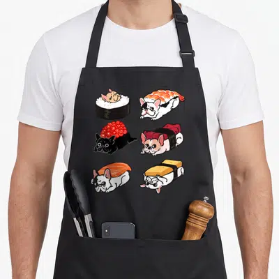 Sushi french bulldog apron - Six cartoon french bulldogs dressed as sushi rolls in white, black, orange, red, and yellow — shown on a black cotton canvas apron against a white background