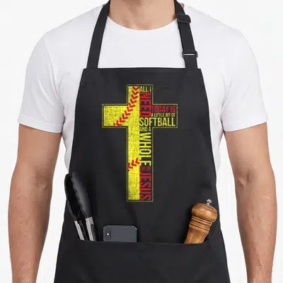 Softball christian apron - Yellow cross with red softball stitches and text 'All I Need Today Is Softball And A Whole — shown on a black cotton canvas apron against a white background