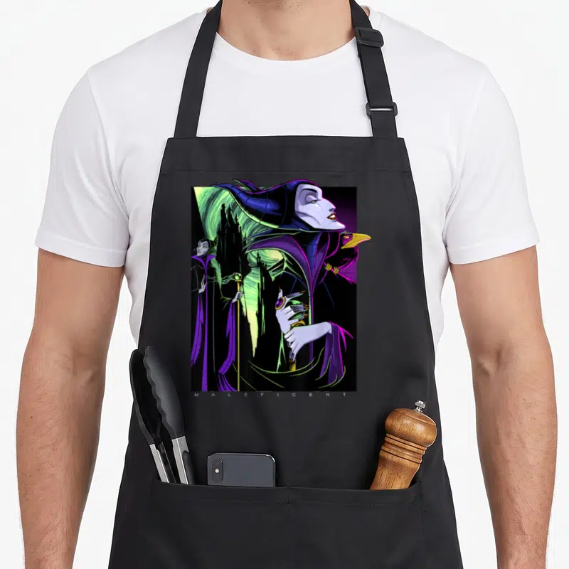 Maleficent portrait beauty apron - Purple Maleficent profile with raven, castle, and MALEFICENT text at bottom — shown on a black cotton canvas apron against a white background
