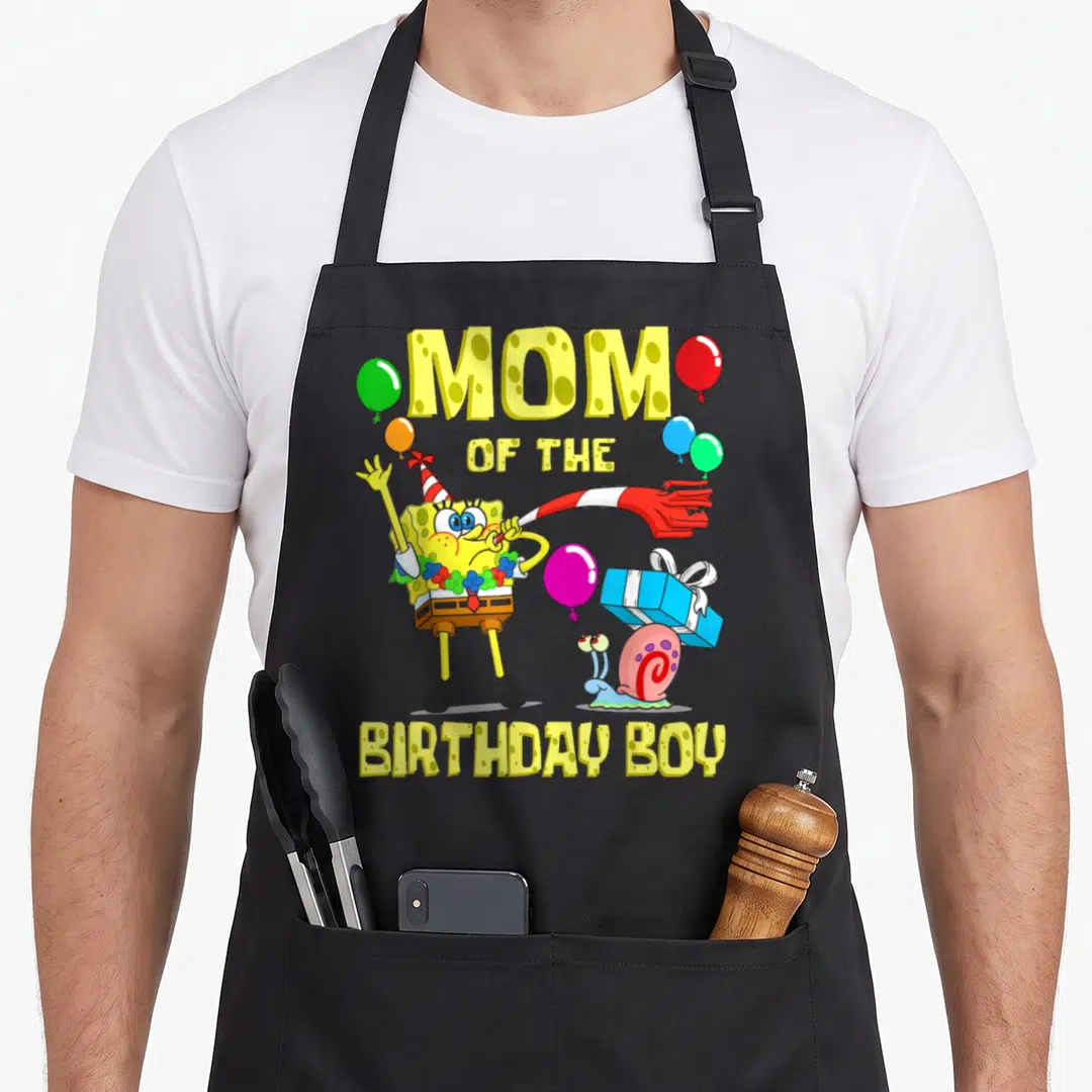 Theme birthday apron - Cartoon sponge wearing party hat and lei with snail carrying gift surrounded by balloons — shown on a black cotton canvas apron against a white background