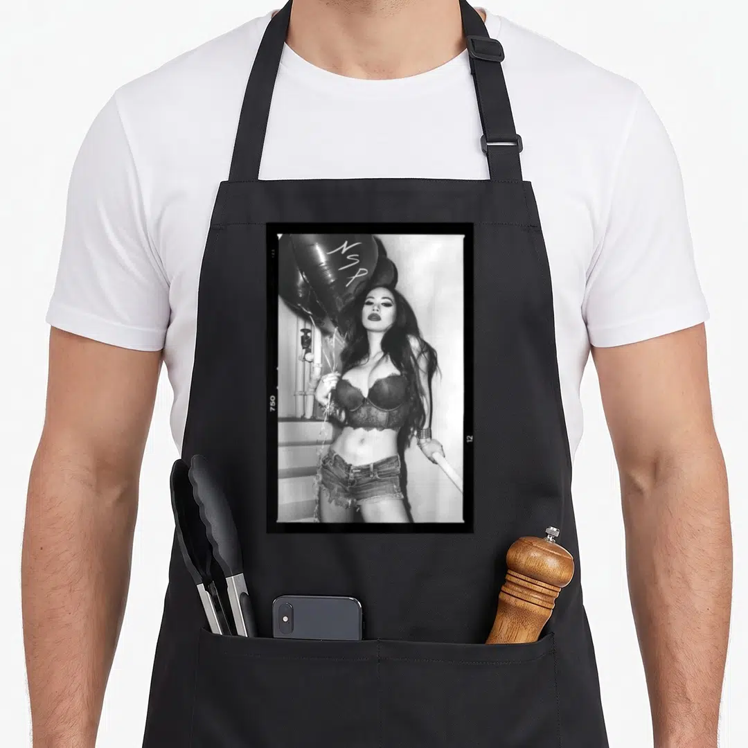 Asian design imports vintage apron - Black and white photo of a woman holding balloons with NSP text inside a polaroid — shown on a black cotton canvas apron against a white background