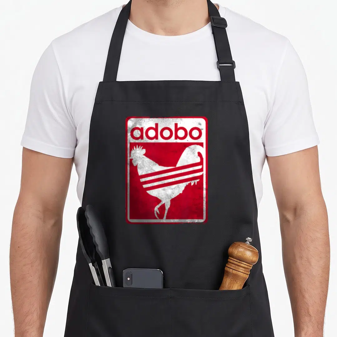 Distressed chicken apron - Red and white rooster silhouette with adobo text in distressed retro style — shown on a black cotton canvas apron against a white background