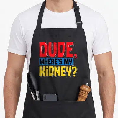 Dude organ apron - Cartoon text DUDE WHERE'S MY KIDNEY in red blue yellow and black — shown on a black cotton canvas apron against a white background