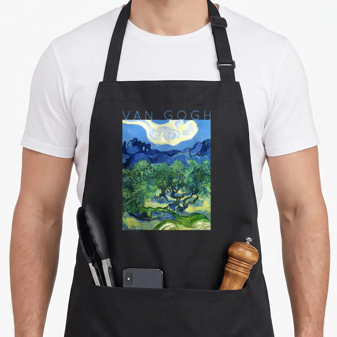 Van tree aprons - Blue text reading Van Gogh above a landscape with green olive trees and yellow sky — shown on a black cotton canvas apron against a white background