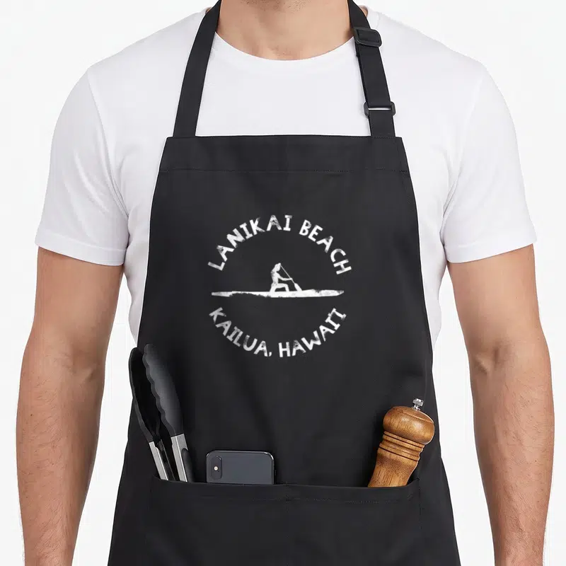 Lanikai kailua apron - White distressed paddleboarder silhouette with arching Lanikai Beach Kailua Hawaii text — shown on a black cotton canvas apron against a white background