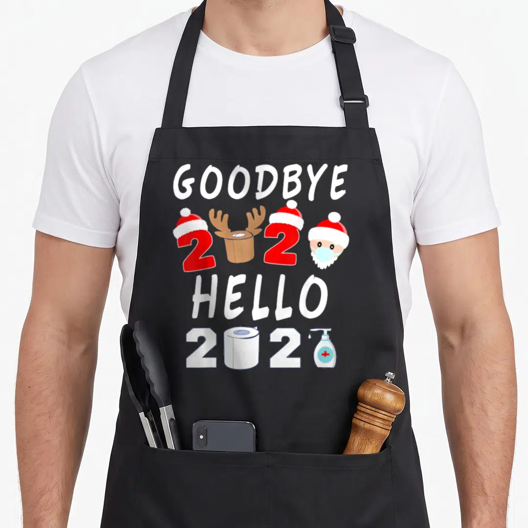 Hello family aprons - Goodbye 2020 Hello 2021 text with toilet paper zeros, masked Santa, and sanitizer bottle — shown on a black cotton canvas apron against a white background