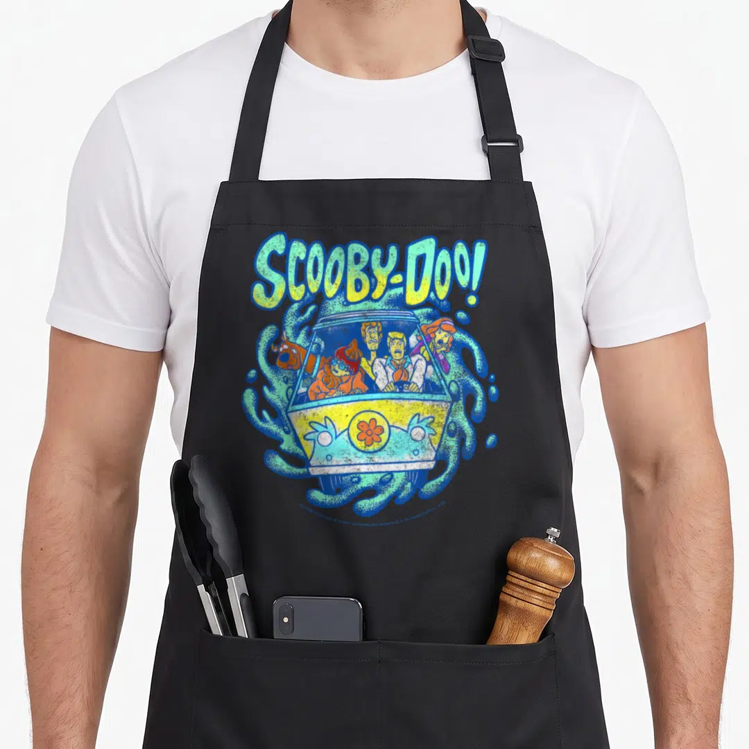 Portal machine apron - Scooby-Doo Mystery Machine cartoon illustration with swirling blue and green patterns — shown on a black cotton canvas apron against a white background