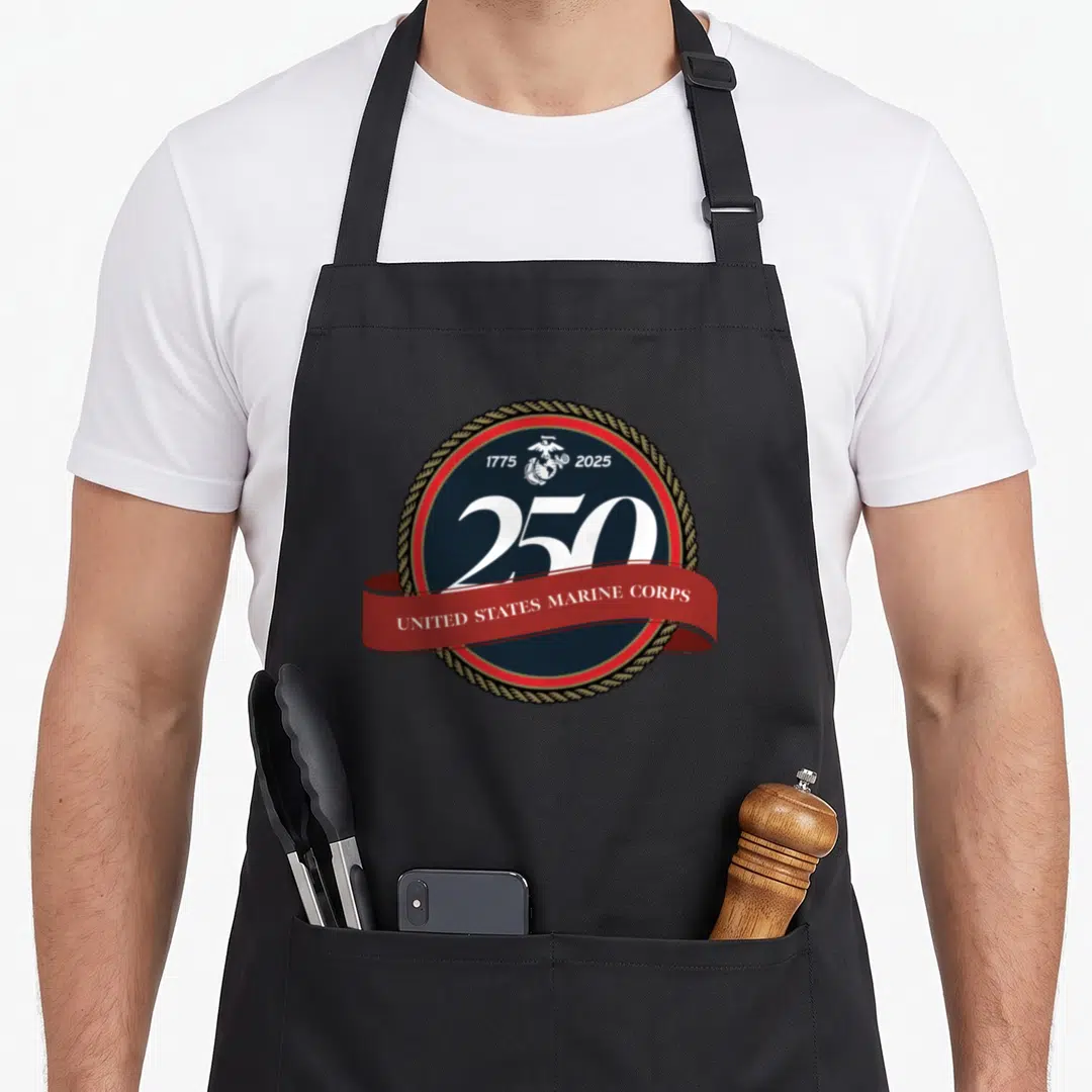 Corp birthday apron - Circular marine corps seal with 250 dates and red ribbon banner — shown on a black cotton canvas apron against a white background