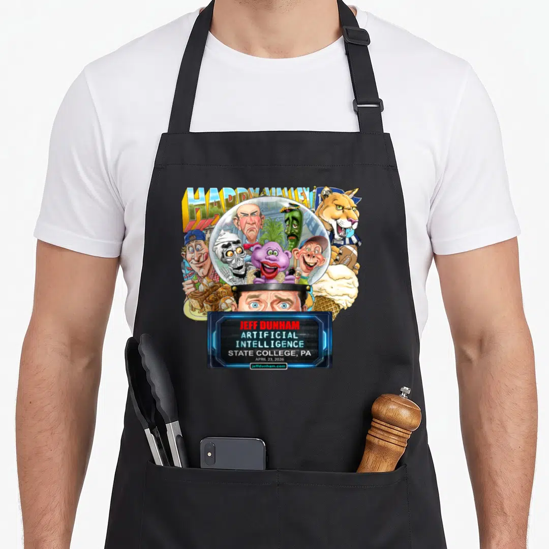 Jeff state college apron - Ventriloquist puppets in glass dome HAPPY VALLEY text Jeff Dunham Artificial Intelligence — shown on a black cotton canvas apron against a white background