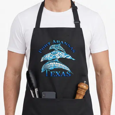 Port texas apron - Two stacked blue and white tribal patterned dolphins under arched PORT ARANSAS and straight TEXAS — shown on a black cotton canvas apron against a white background