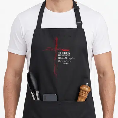 Religious scripture bible verse apron - Red distressed cross with white Psalm 23 text stacked to the right — shown on a black cotton canvas apron against a white background