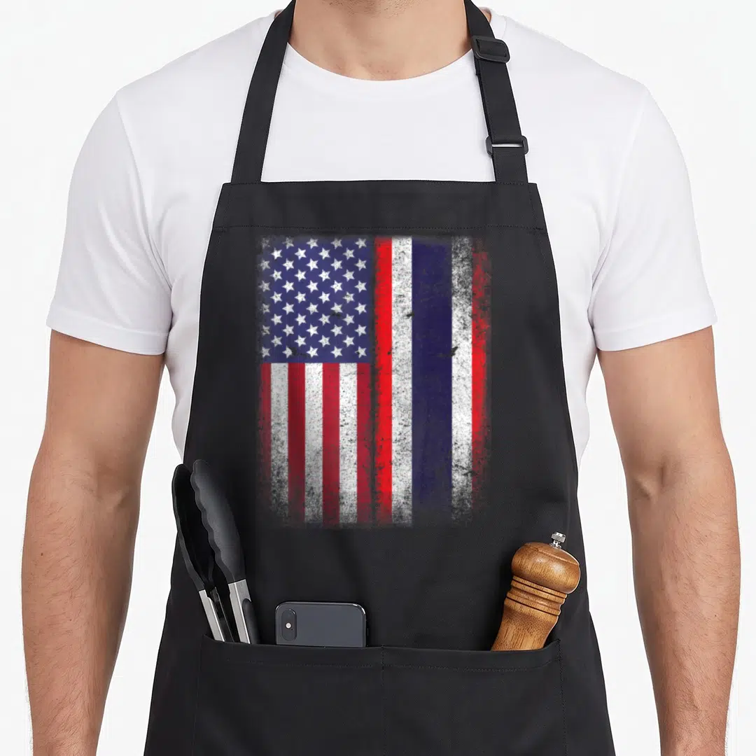 Thai american flag apron - Distressed American and Thai flags side-by-side in red white and blue — shown on a black cotton canvas apron against a white background