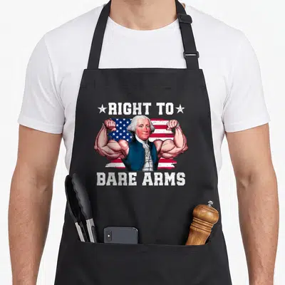 Right 4th of july apron - Cartoon muscular man flexing in front of red white and blue flag with right to bare arms text — shown on a black cotton canvas apron against a white background