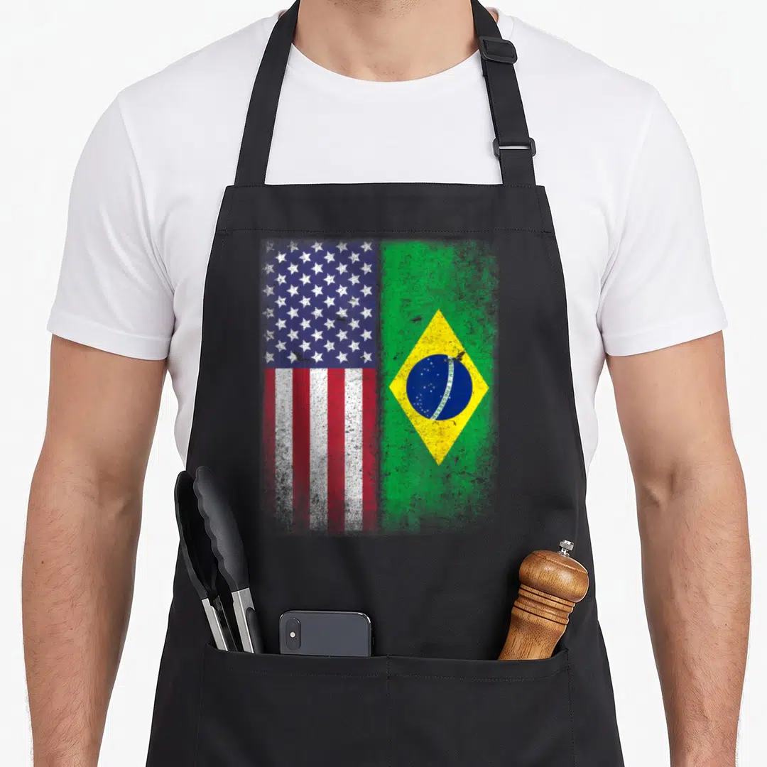 Brazil american flag apron - Distressed USA and Brazil flags side-by-side with ORDEM E PROGRESSO text — shown on a black cotton canvas apron against a white background