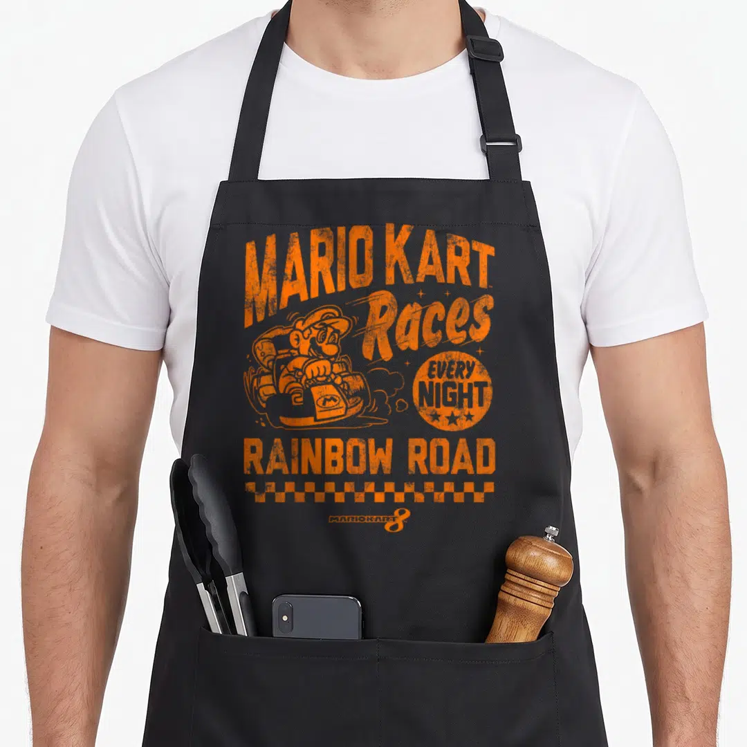 Rainbow road apron - Orange Mario Kart Races Every Night Rainbow Road checkered border graphic — shown on a black cotton canvas apron against a white background
