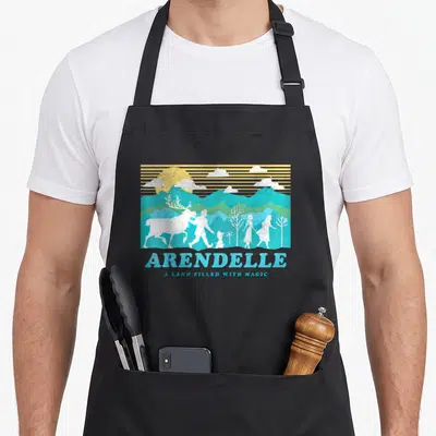 Arendelle frozen apron - Retro Arendelle landscape with Sven reindeer silhouette and stacked text in blue teal yellow — shown on a black cotton canvas apron against a white background