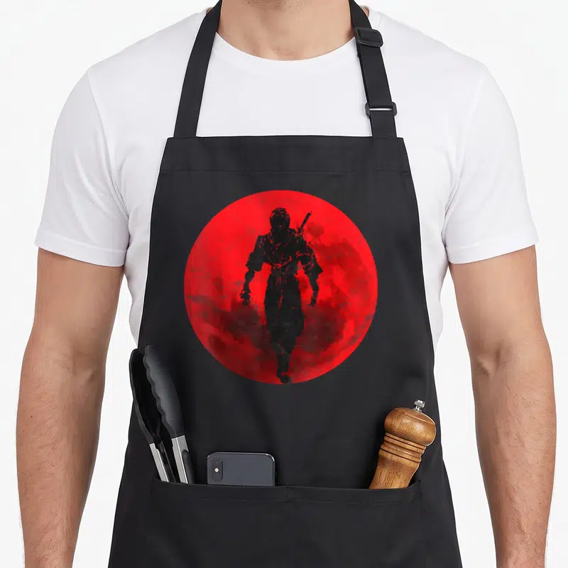 Figher japan apron - Black samurai silhouette holding a sword centered inside a large distressed red circle — shown on a black cotton canvas apron against a white background