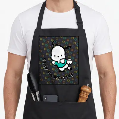 Pochacco paw apron - Cartoon white dog holding paw up with STAY PAWSITIVE text and colorful circles on grey — shown on a black cotton canvas apron against a white background