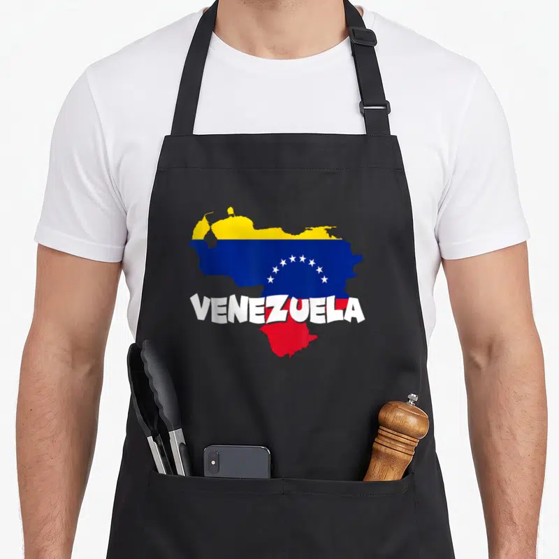 Venezuela patriotic apron - Map of Venezuela filled with yellow blue red flag colors and white VENEZUELA text — shown on a black cotton canvas apron against a white background