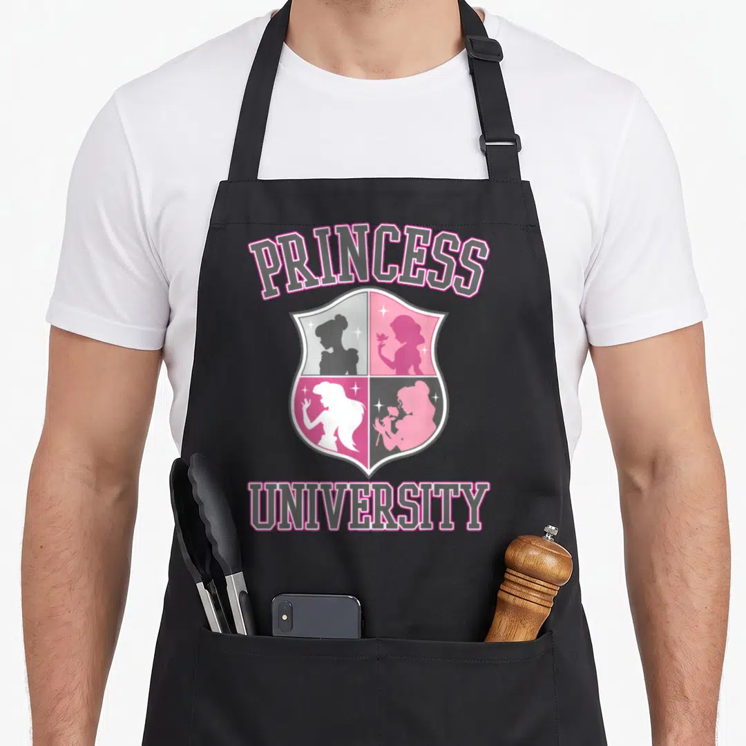 University princess apron - Arched PRINCESS and straight UNIVERSITY text surrounding a four-quadrant shield — shown on a black cotton canvas apron against a white background