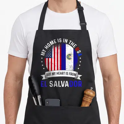Patriot salvadoran apron - Distressed combined US and El Salvador flag in circle with arched text and scattered white — shown on a black cotton canvas apron against a white background