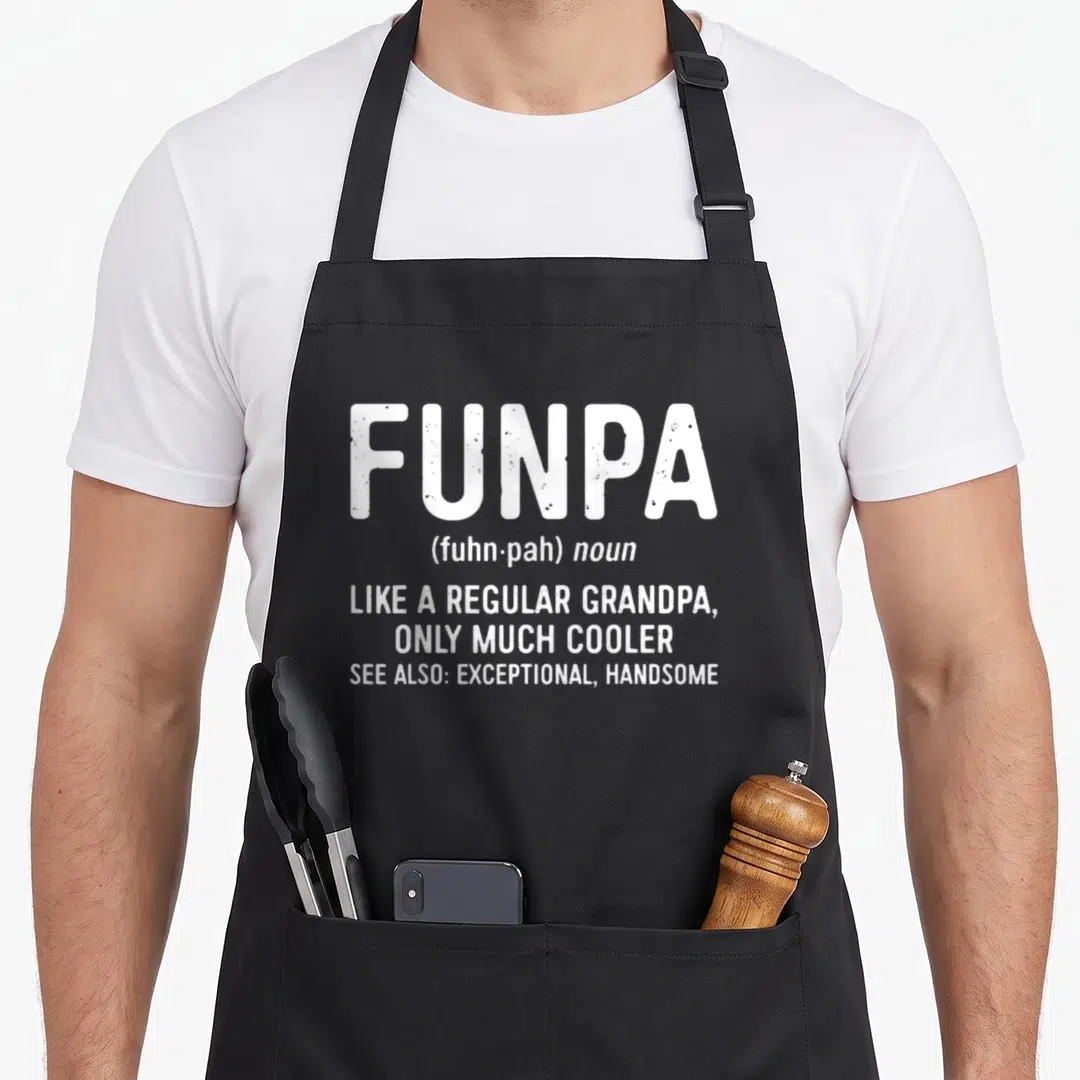Funpa grandpa apron - White dictionary definition text reading funpa like a regular grandpa only much cooler — shown on a black cotton canvas apron against a white background
