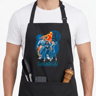 Step family aprons - Four superheroes in blue suits with orange fire element and logo text at bottom — shown on a black cotton canvas apron against a white background