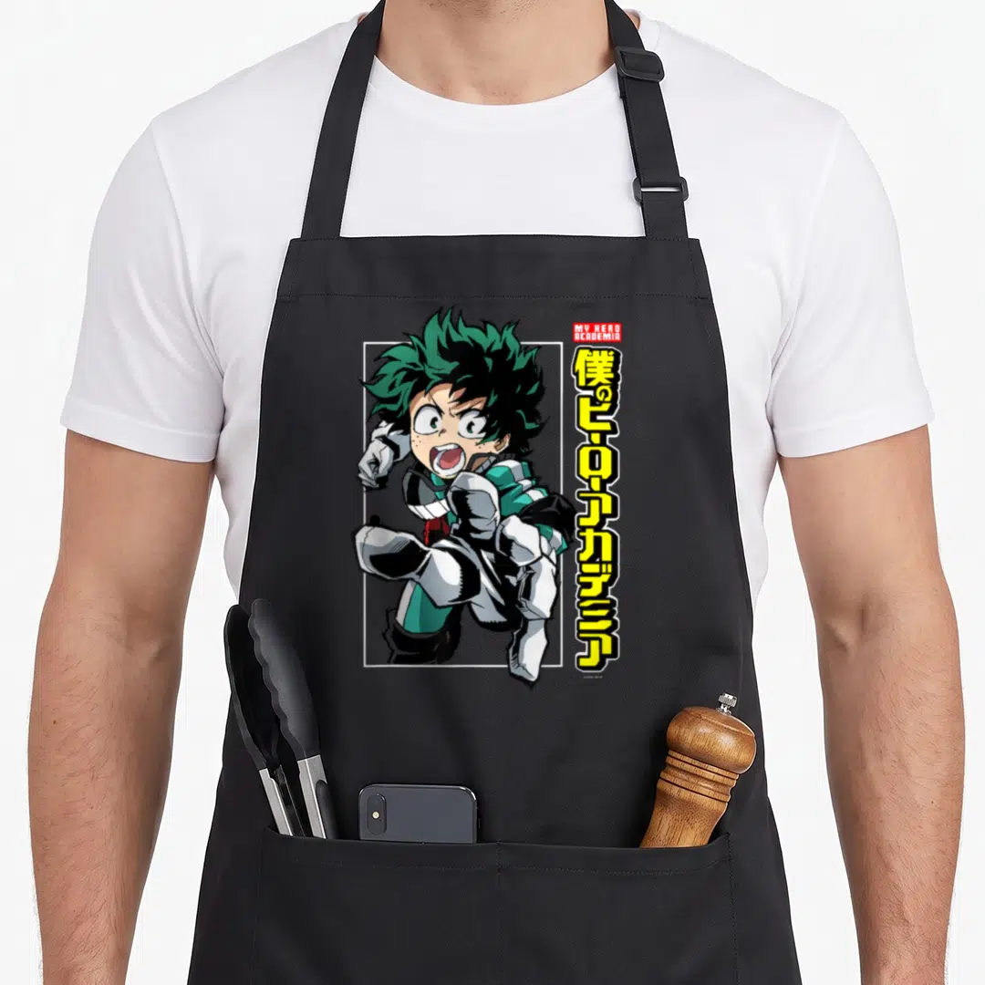 Deku anime apron - Izuku Midoriya running pose with red My Hero Academia box and vertical yellow Japanese text — shown on a black cotton canvas apron against a white background