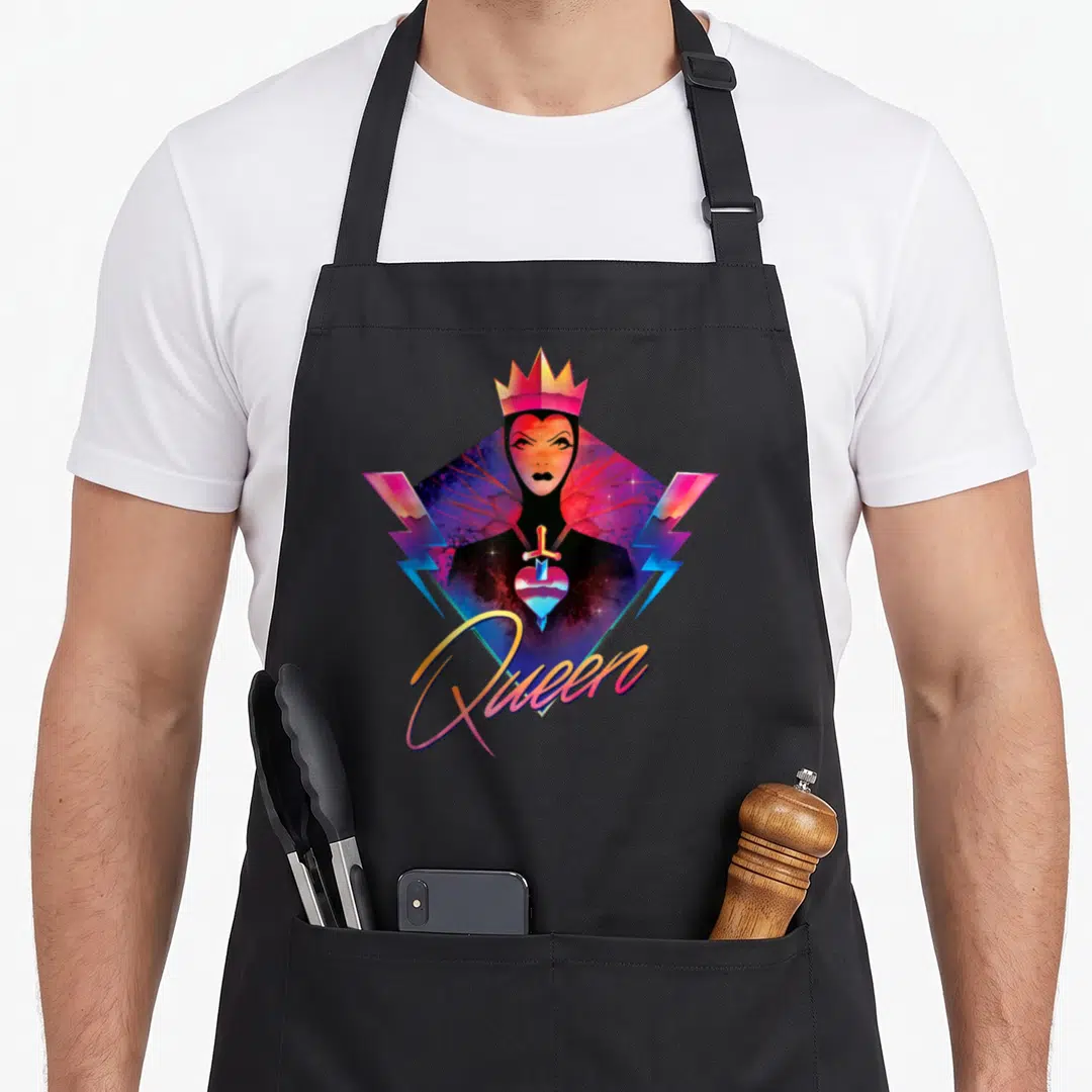 Villain 90s apron - Cartoon queen in diamond with crown, sword through heart, lightning bolts, 'Queen' text, purple — shown on a black cotton canvas apron against a white background