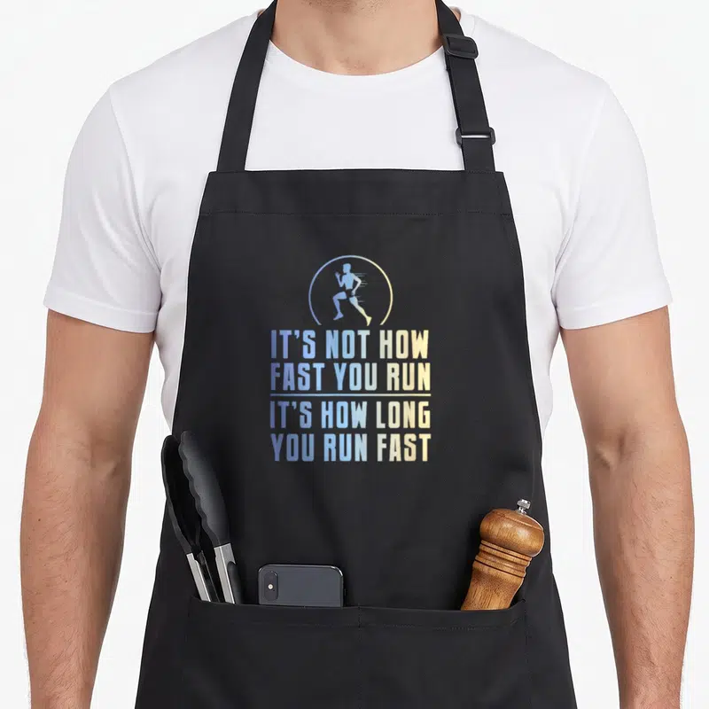 Distance country apron - Runner silhouette in circle above blue and yellow stacked text about running endurance — shown on a black cotton canvas apron against a white background