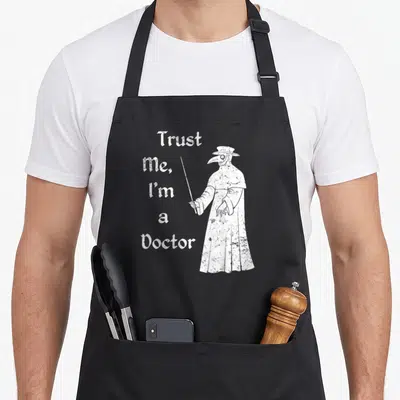 Trust plague doctor apron - White distressed text Trust Me I'm a Doctor beside a plague doctor figure pointing a cane — shown on a black cotton canvas apron against a white background