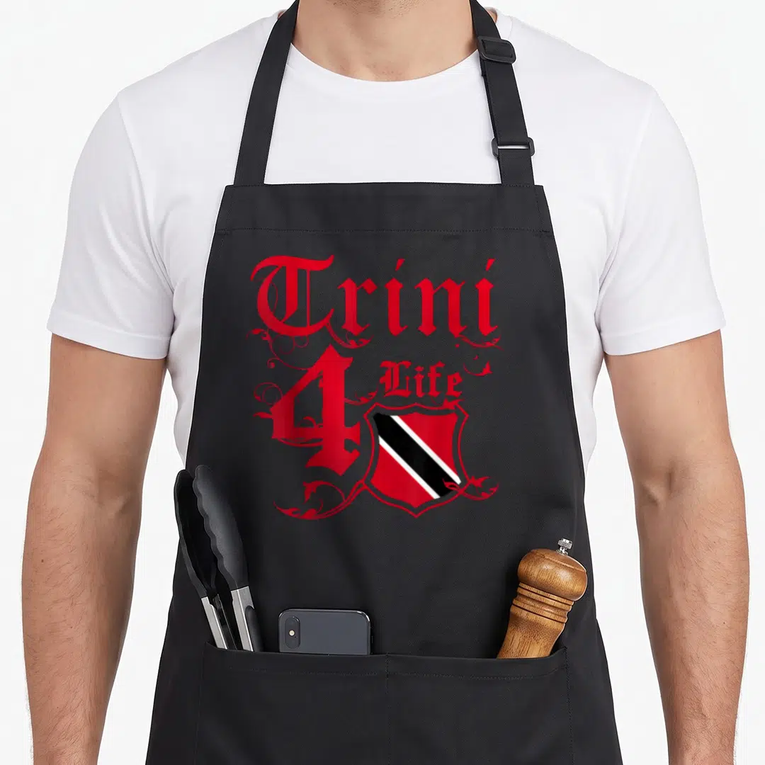 Trini4life trinidad and tobago apron - Red Trini 4 Life gothic text with swirling decorations above a shield containing — shown on a black cotton canvas apron against a white background