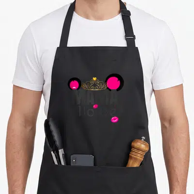 Outfit mama apron - Stylized mouse head with gold crown, MAMA Mouse text, and pink lips — shown on a black cotton canvas apron against a white background