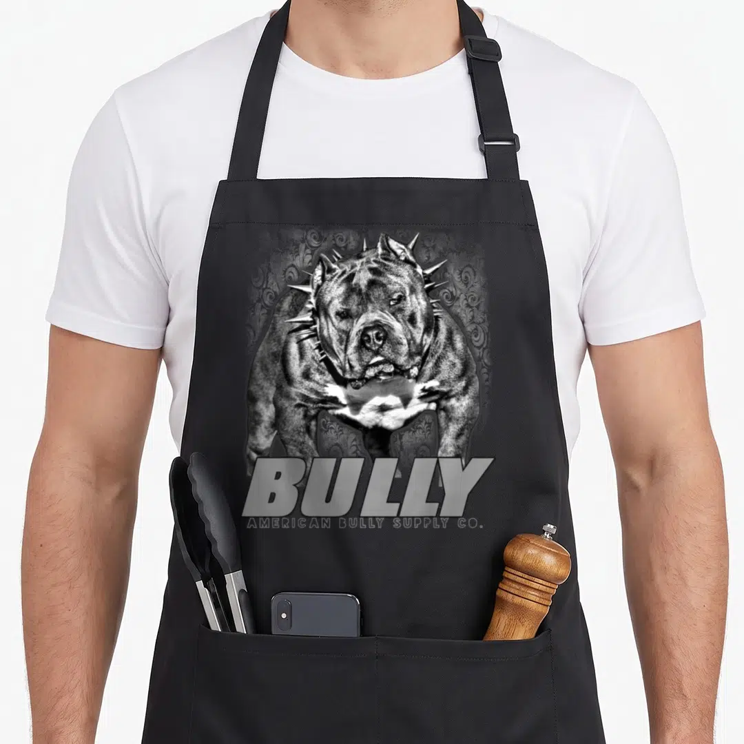 Bully bull apron - Realistic grey and white dog with spiked collar and BULLY text — shown on a black cotton canvas apron against a white background