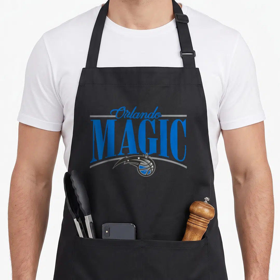 Arch magic apron - Orlando MAGIC text with basketball and trailing star in blue silver and black — shown on a black cotton canvas apron against a white background
