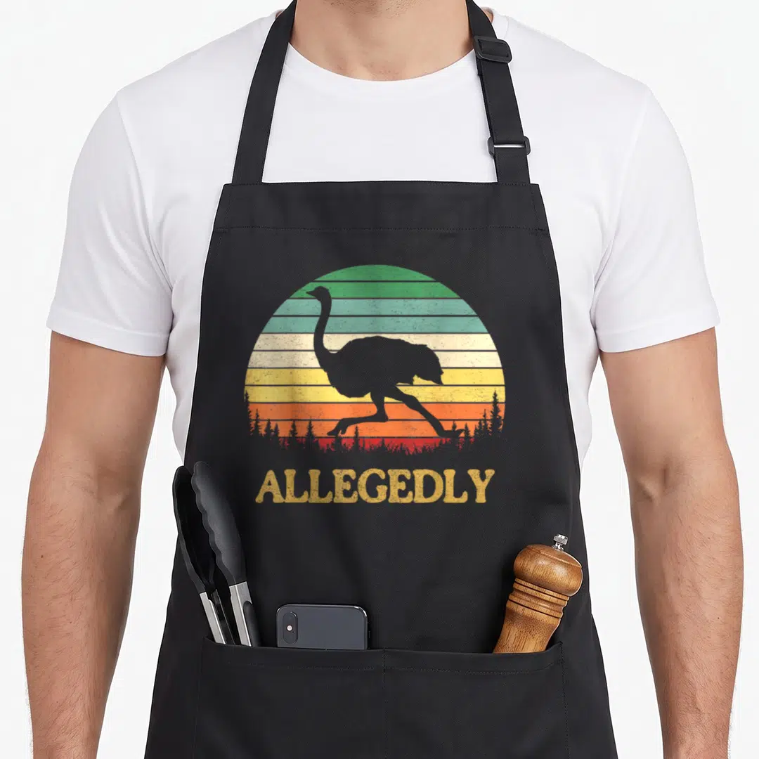 Allegedly crew apron - Grey ostrich silhouette against striped retro sun with ALLEGEDLY text below — shown on a black cotton canvas apron against a white background