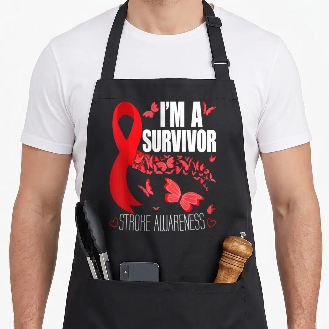 Attack ribbon apron - Red ribbon, white survivor text, and red butterflies flanking bottom hearts — shown on a black cotton canvas apron against a white background
