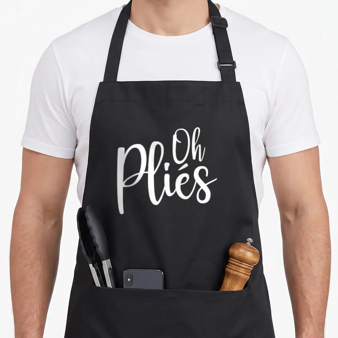 Ply ballet dance apron - White script text reading Oh Pliés stacked vertically — shown on a black cotton canvas apron against a white background