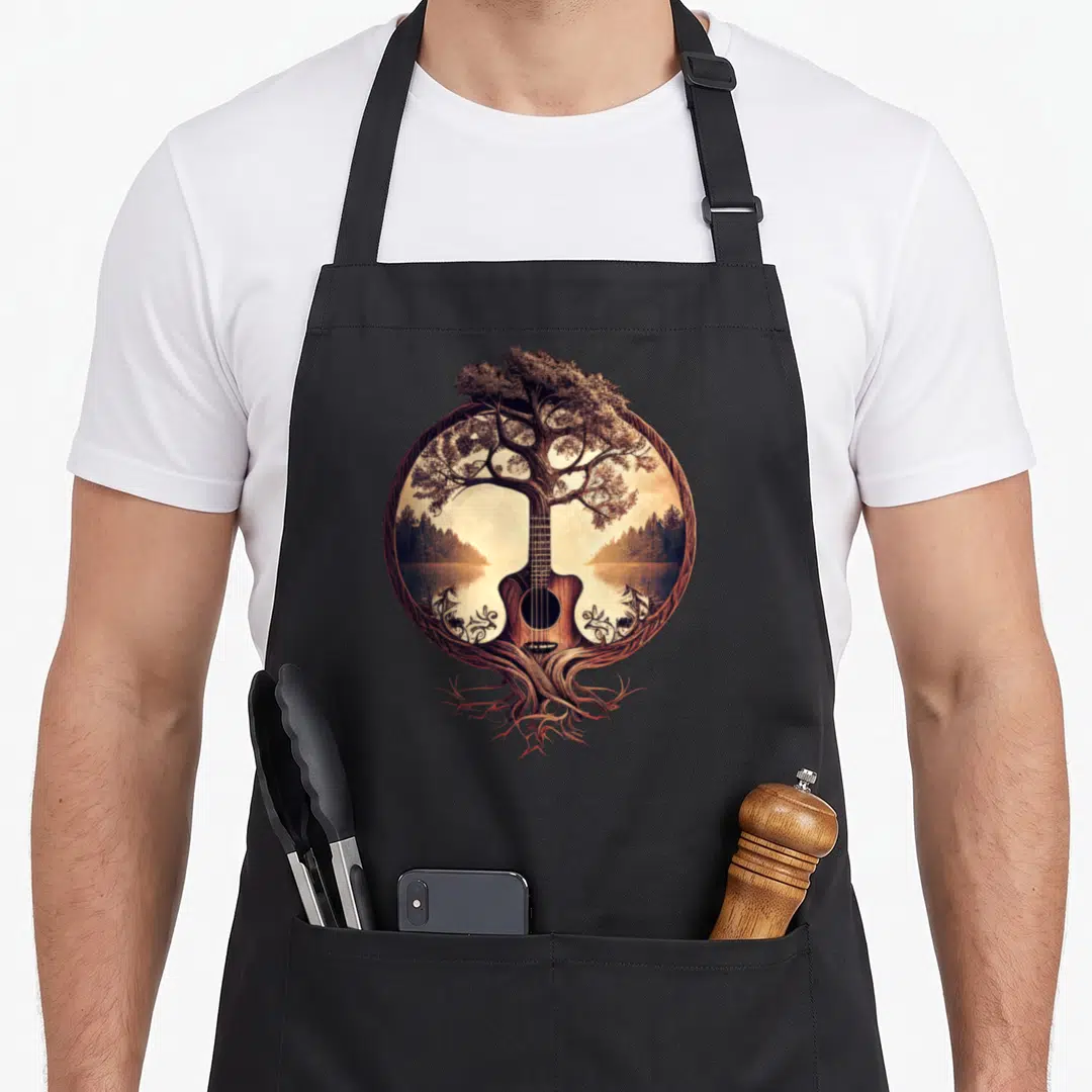 Acoustic guitar tree apron - Realistic acoustic guitar fused with tree trunk in circular forest landscape frame — shown on a black cotton canvas apron against a white background