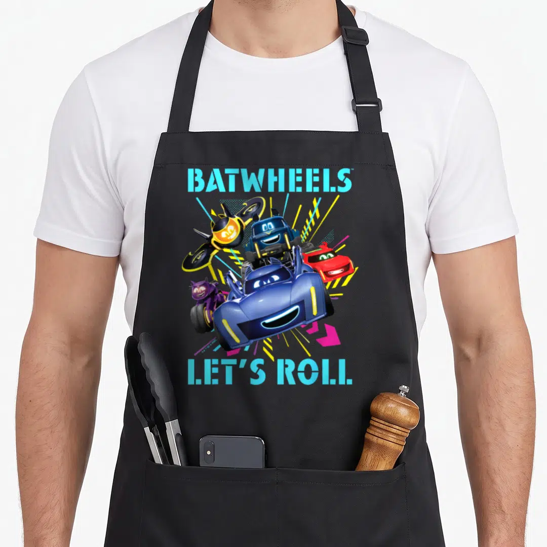 Batwheel girl birthday apron - Four smiling cartoon vehicles with blue text BATWHEELS and LET'S ROLL — shown on a black cotton canvas apron against a white background
