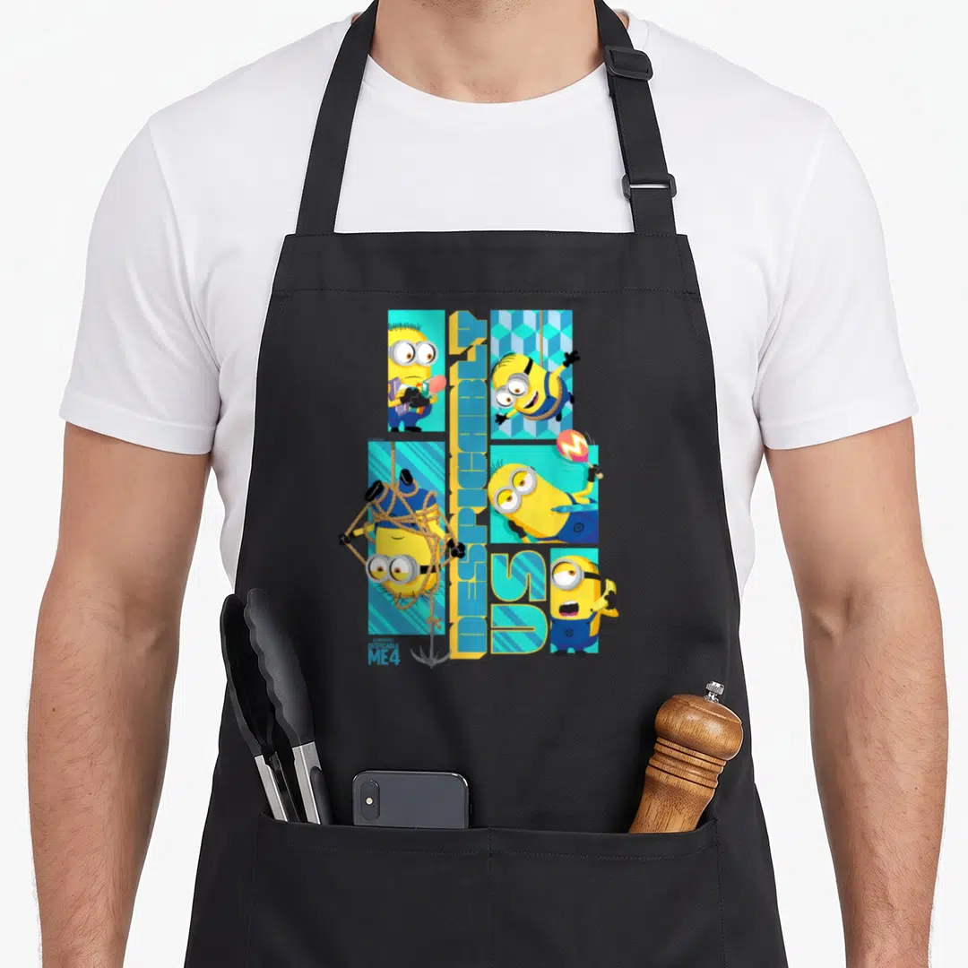 Despicable us aprons - Four Minions in poses around vertical Despicable Me 4 text — shown on a black cotton canvas apron against a white background