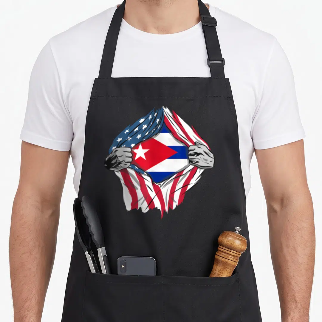 Blood american flag apron - Two grey hands rip USA flag to reveal Cuban flag in red white blue — shown on a black cotton canvas apron against a white background