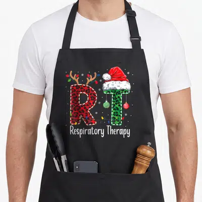 Respiratory christmas apron - Red R with antlers and green T with Santa hat and string lights — shown on a black cotton canvas apron against a white background