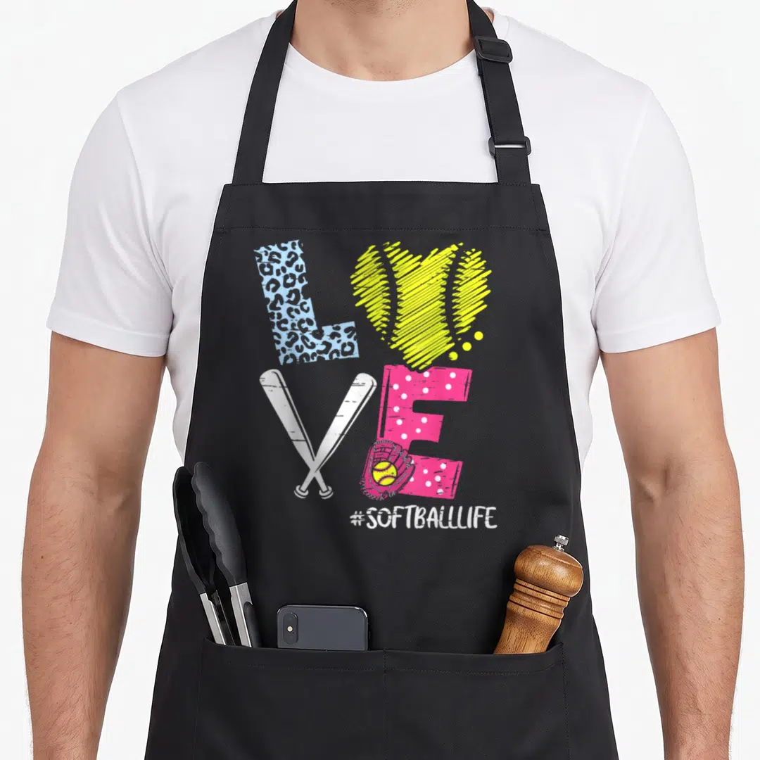 Coach player i love softball apron - LOVE formed by bats glove and leopard print above #SOFTBALLLIFE text — shown on a black cotton canvas apron against a white background