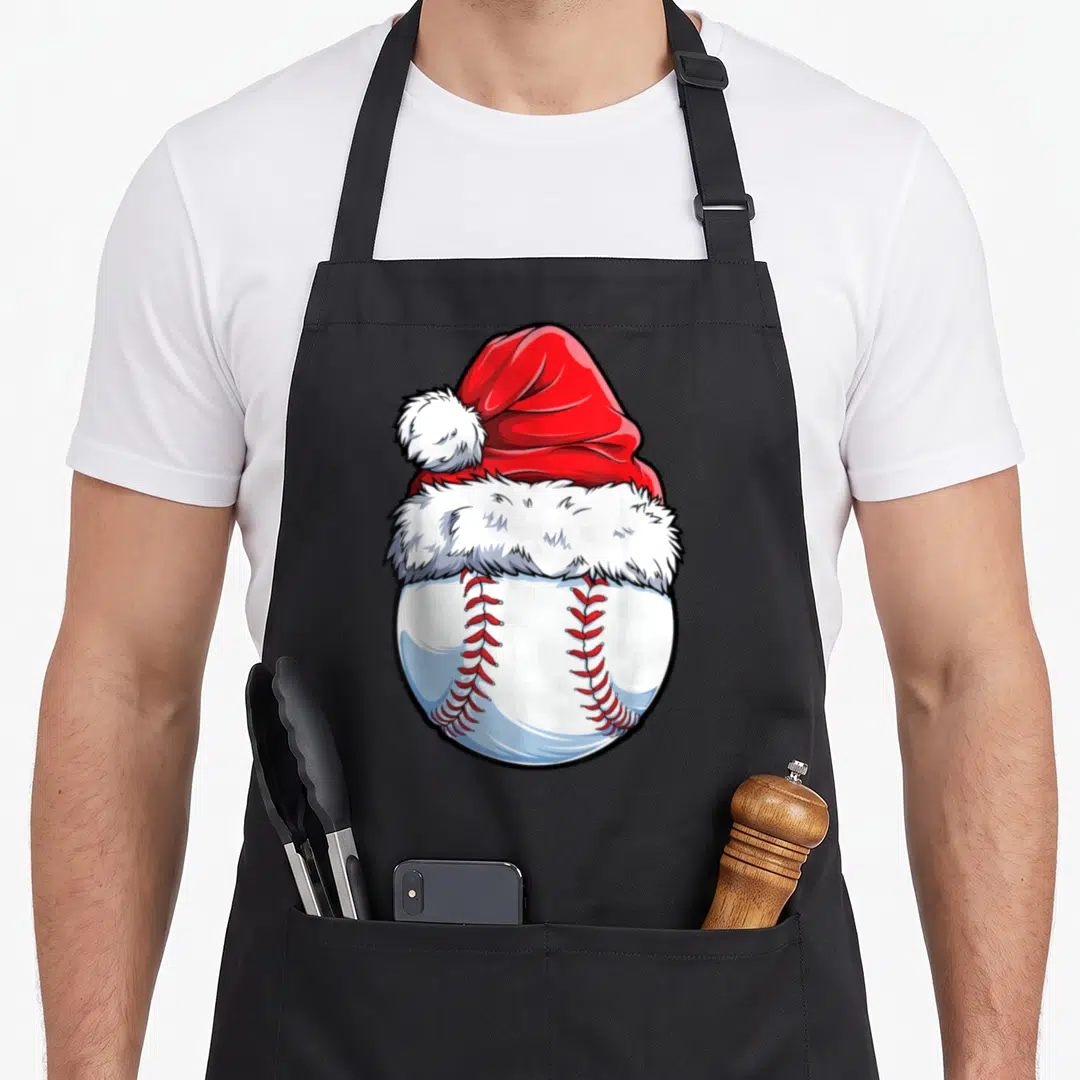 Baseball santa aprons - Red Santa hat on white baseball with red stitching cartoon graphic — shown on a black cotton canvas apron against a white background